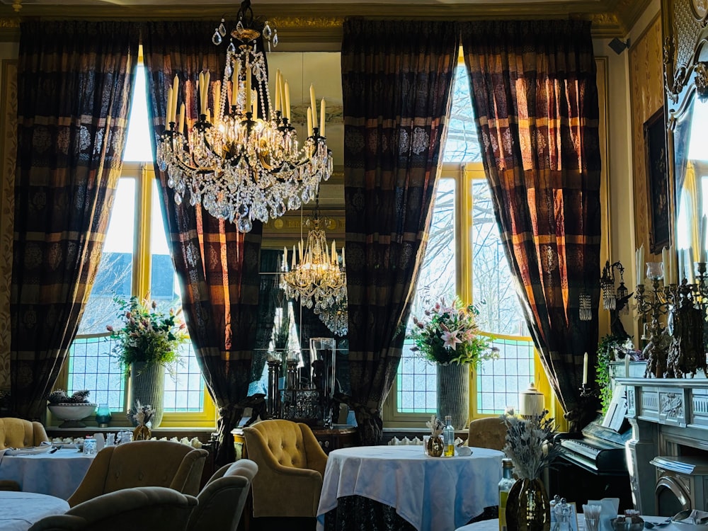 a fancy dining room with chandelier and chandeliers