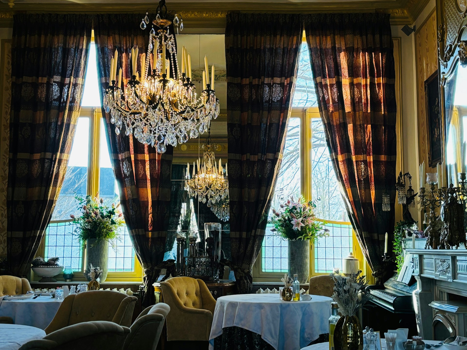 a fancy dining room with chandelier and chandeliers