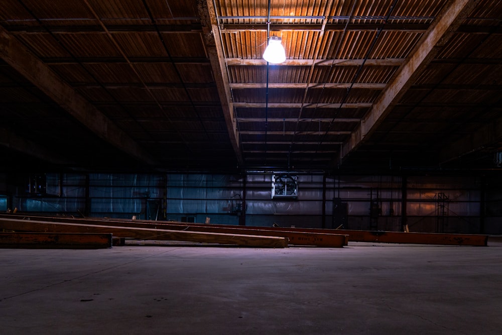 an empty warehouse with a light hanging from the ceiling