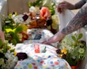 a person reaching for a flower on a table