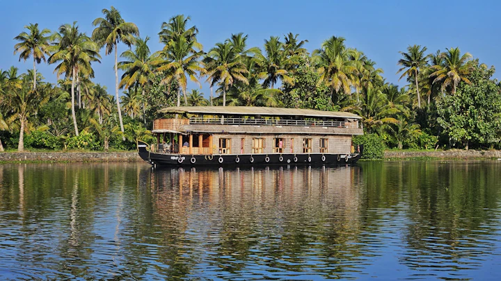 Houseboat on a Kumarakom backwater lined with palms, wedding destination