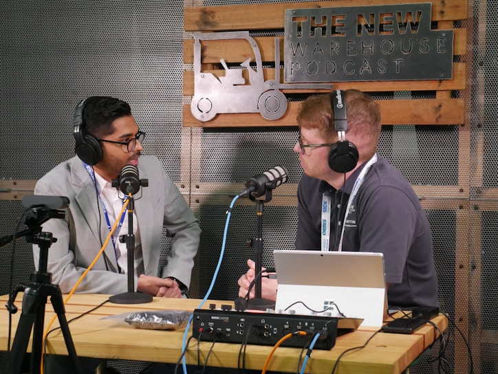 Two men recording a podcast with microphones and microphones.