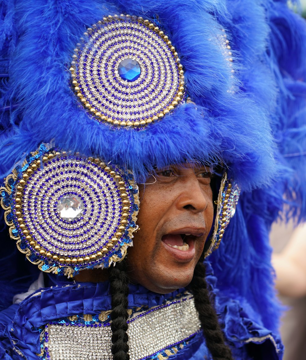a man wearing a blue costume and headdress