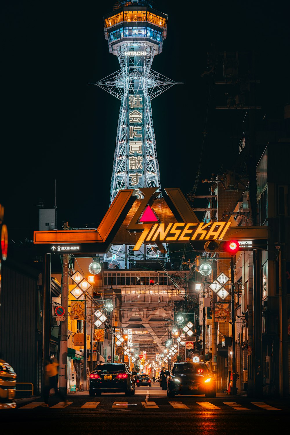 a very tall tower with a neon sign above it