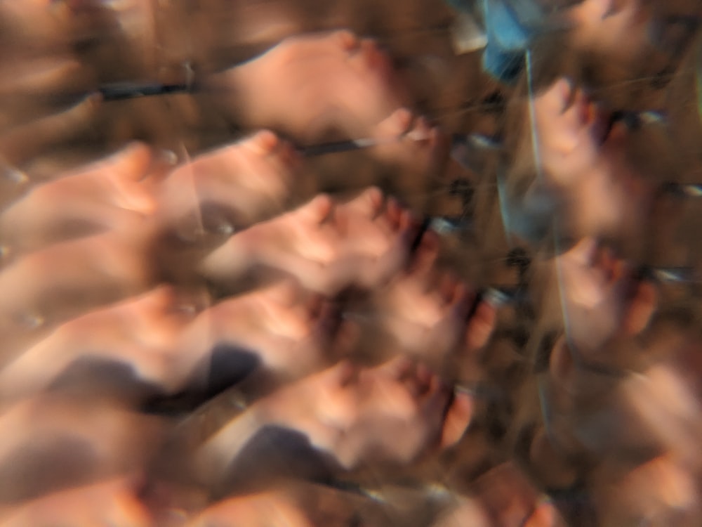 a blurry photo of a person's feet and hands