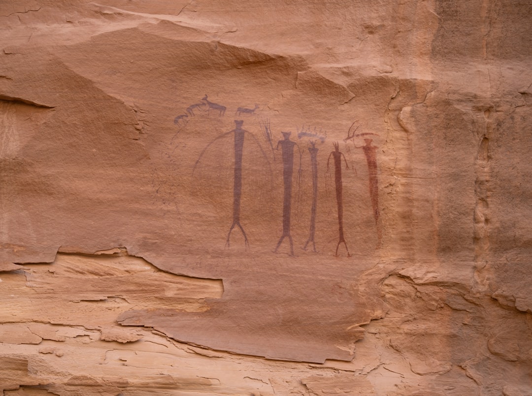A rock wall with a painting of trees on it,