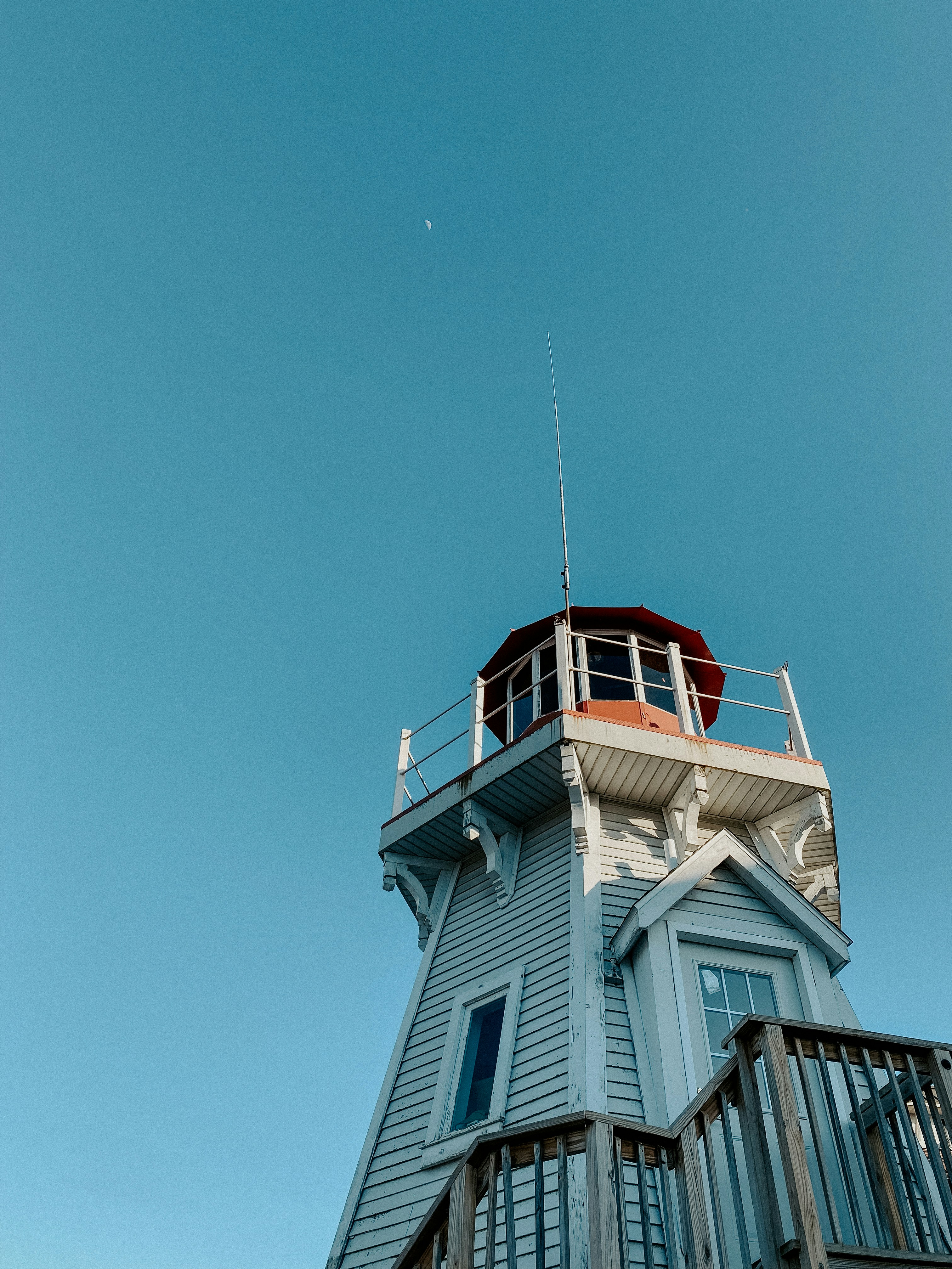 a tall white building with a red top