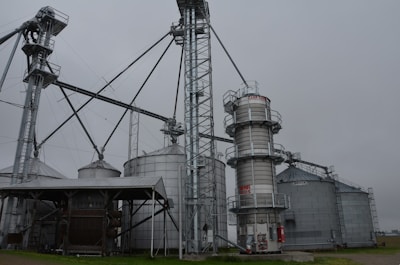a large metal silo sitting next to a building