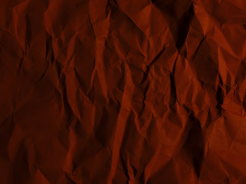 a piece of red paper that has been wrinkled