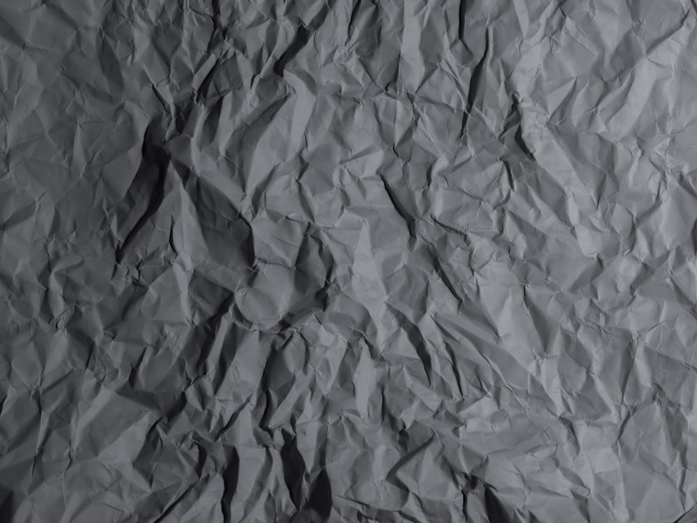 a black and white photo of wrinkled paper