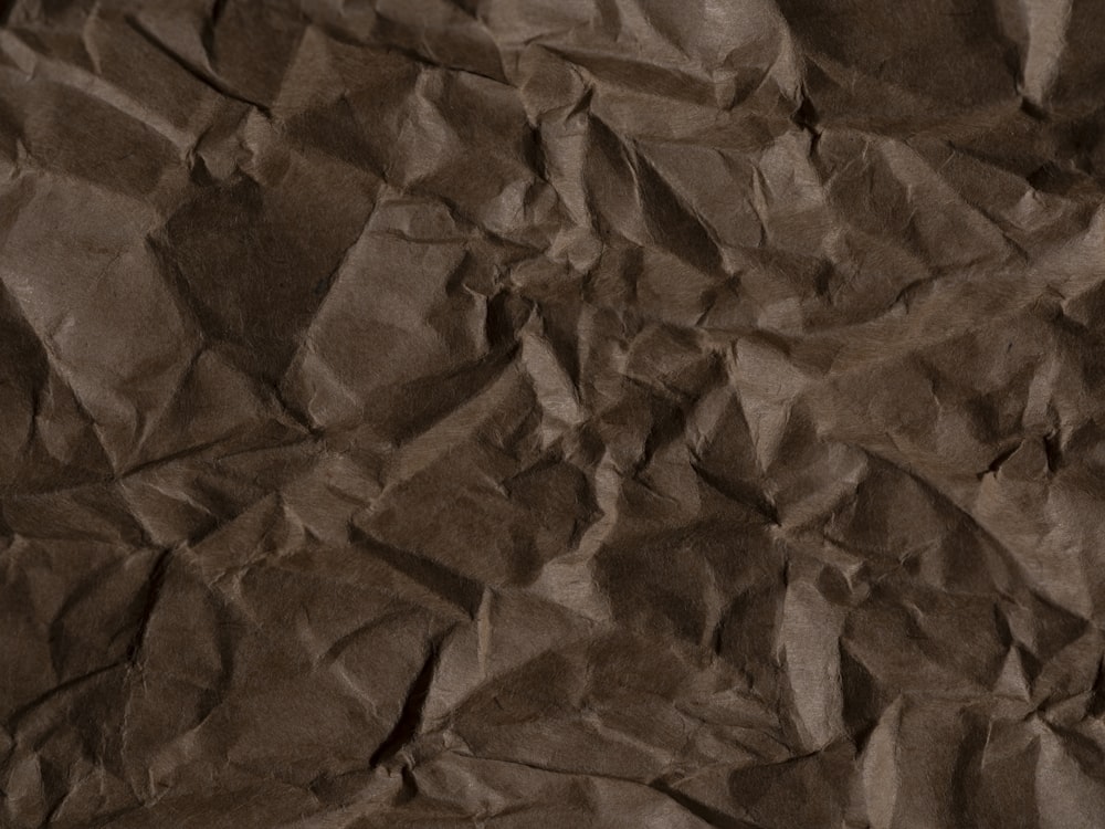 a piece of brown paper that is crumpled