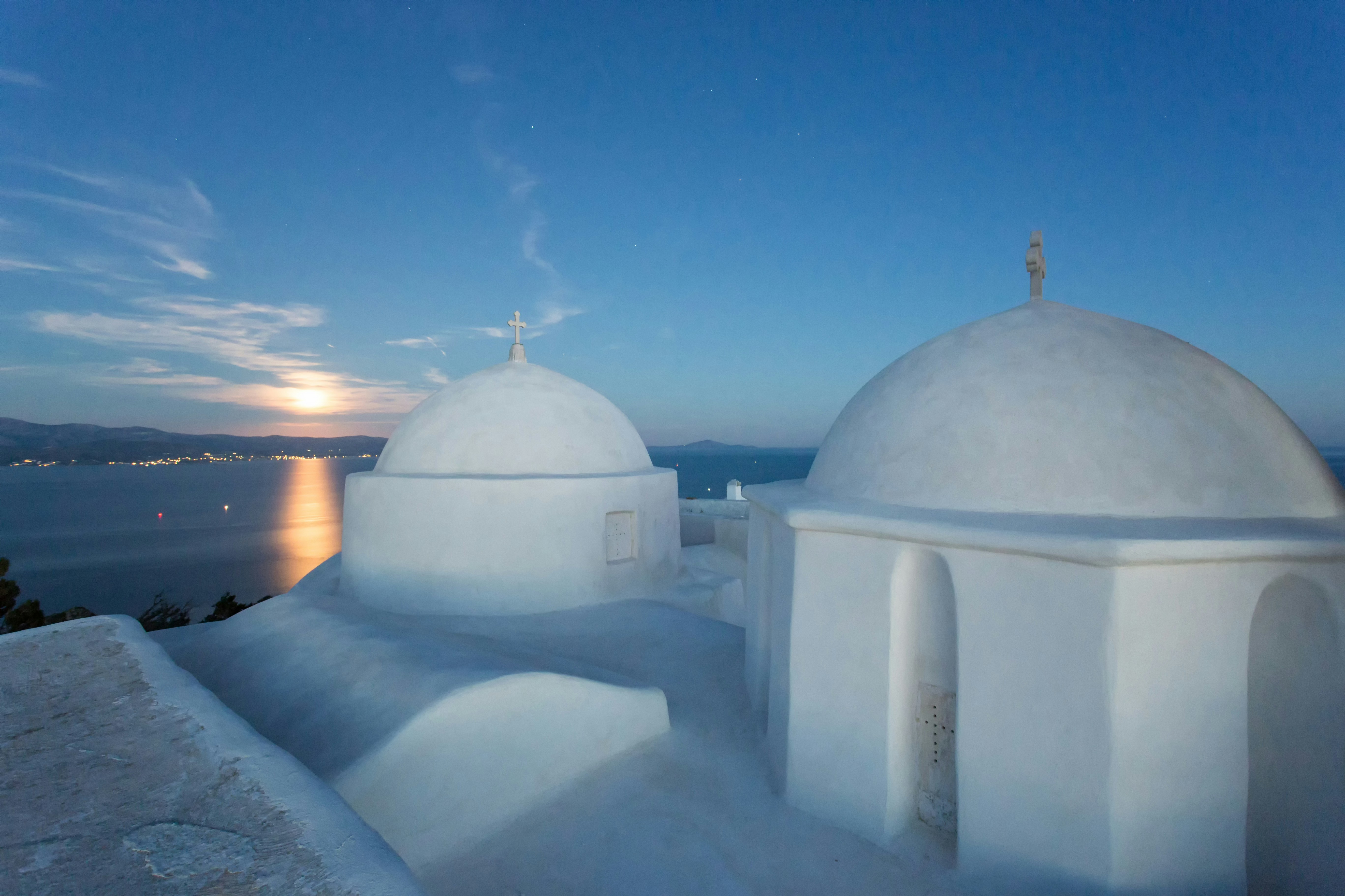 a white building with a cross on top of it