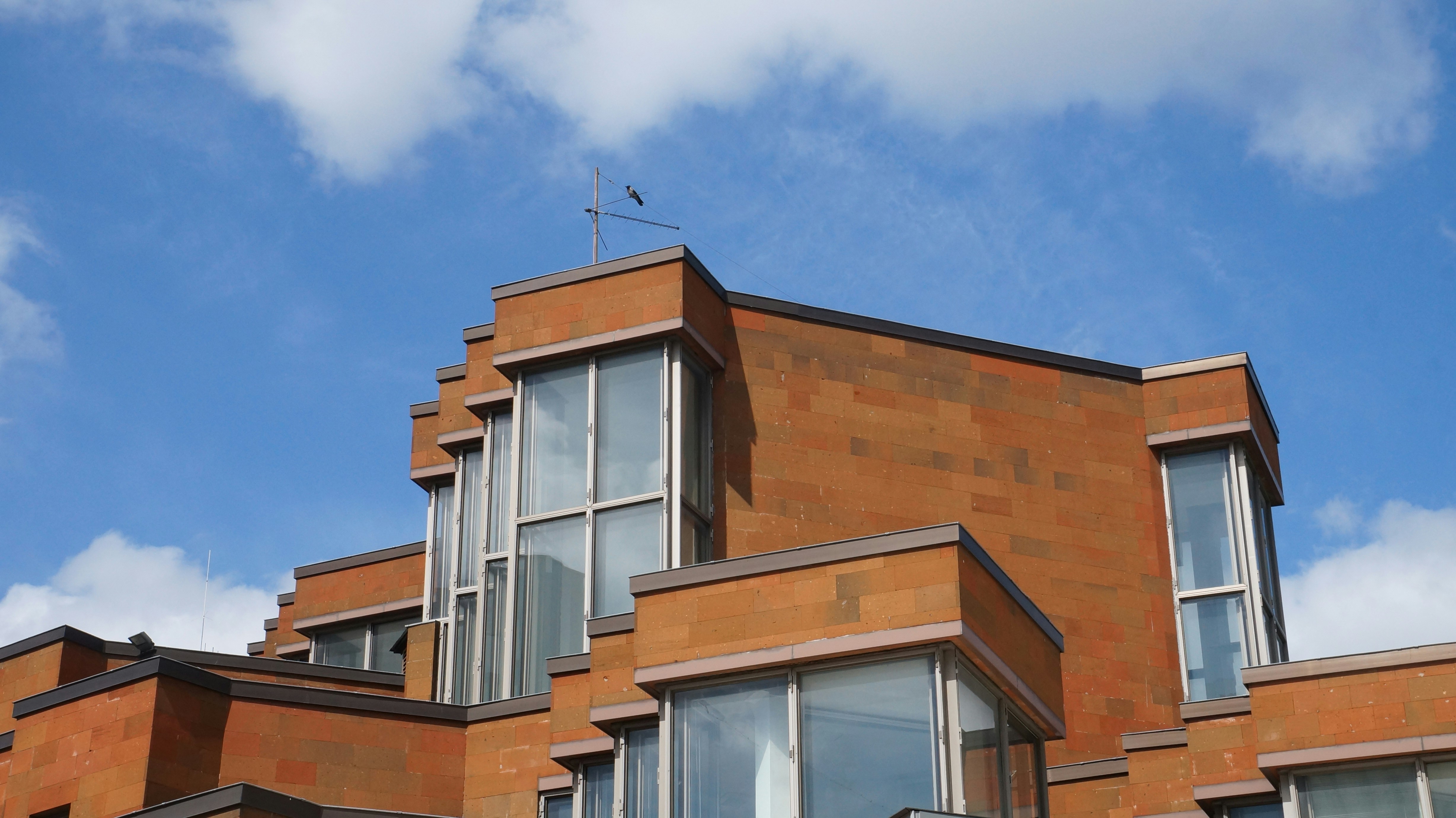 a red brick building with a weather vane on top of it