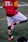 a man in a red and yellow uniform kicking a soccer ball