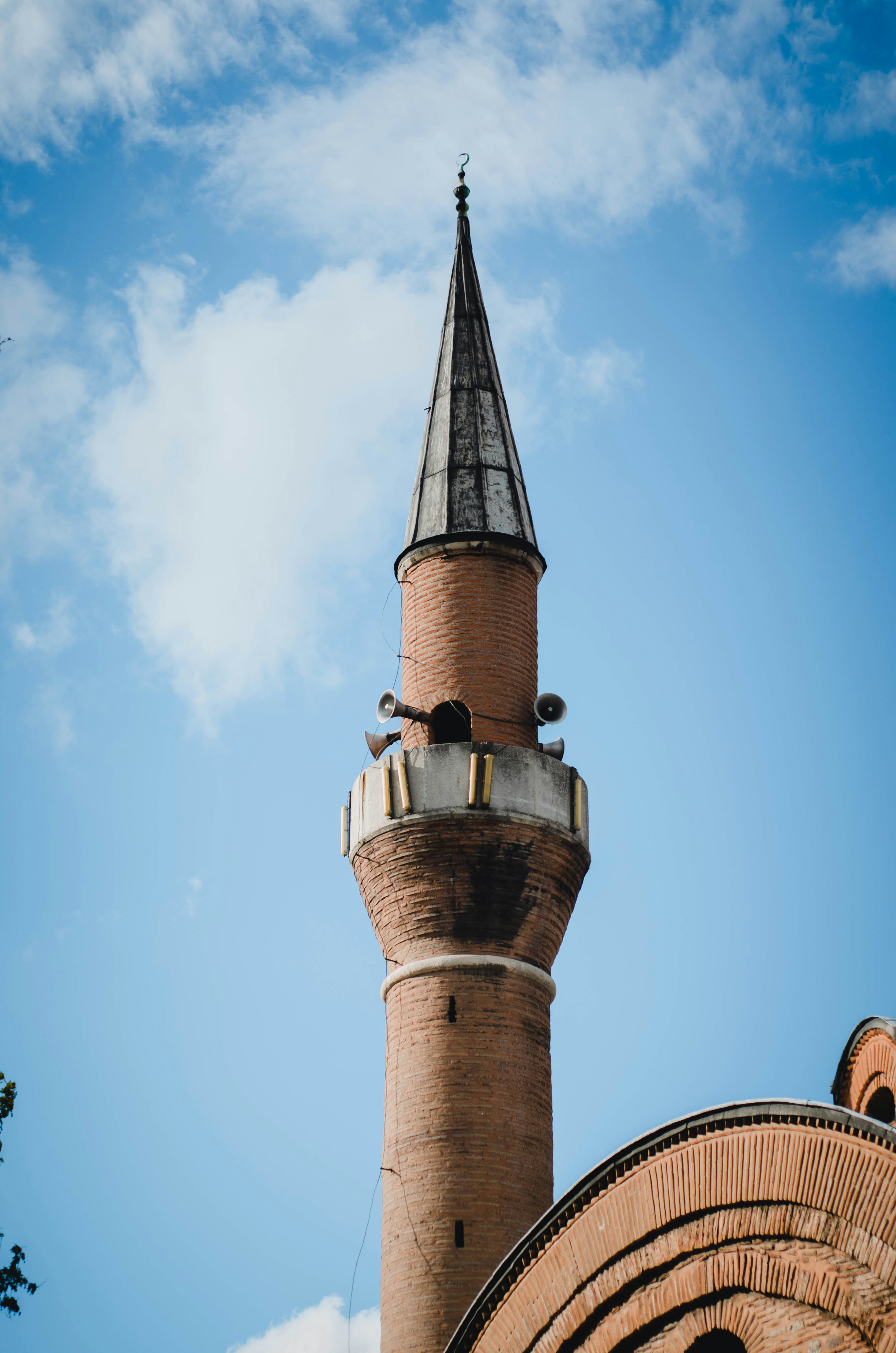 a tall brick tower with a clock on top