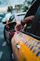 a man is holding his hand out of a car window