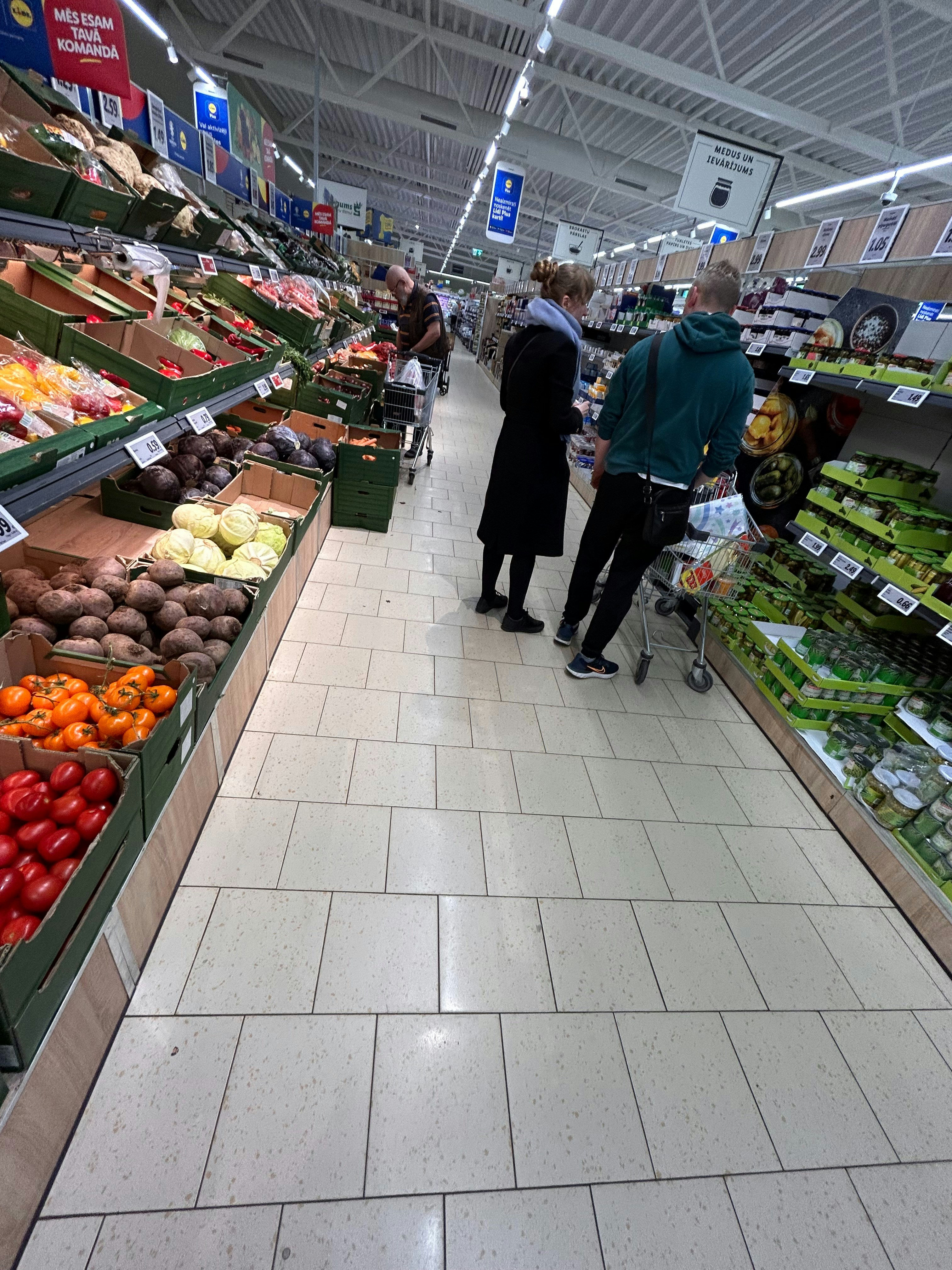 Supermarket aisle with bright lighting and colourful produce, well-stocked shelves in modern store