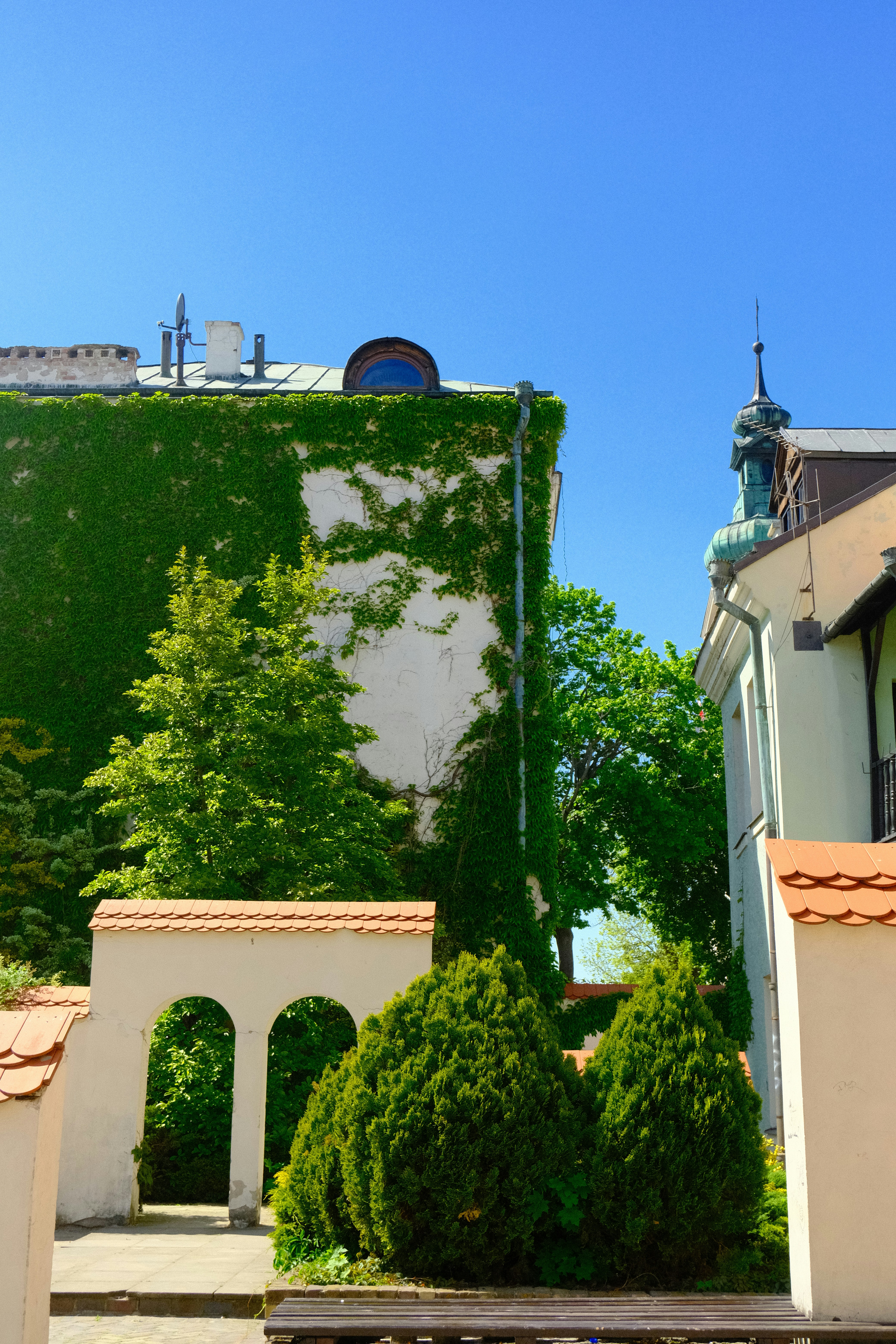 a building with a green wall and a bench in front of it