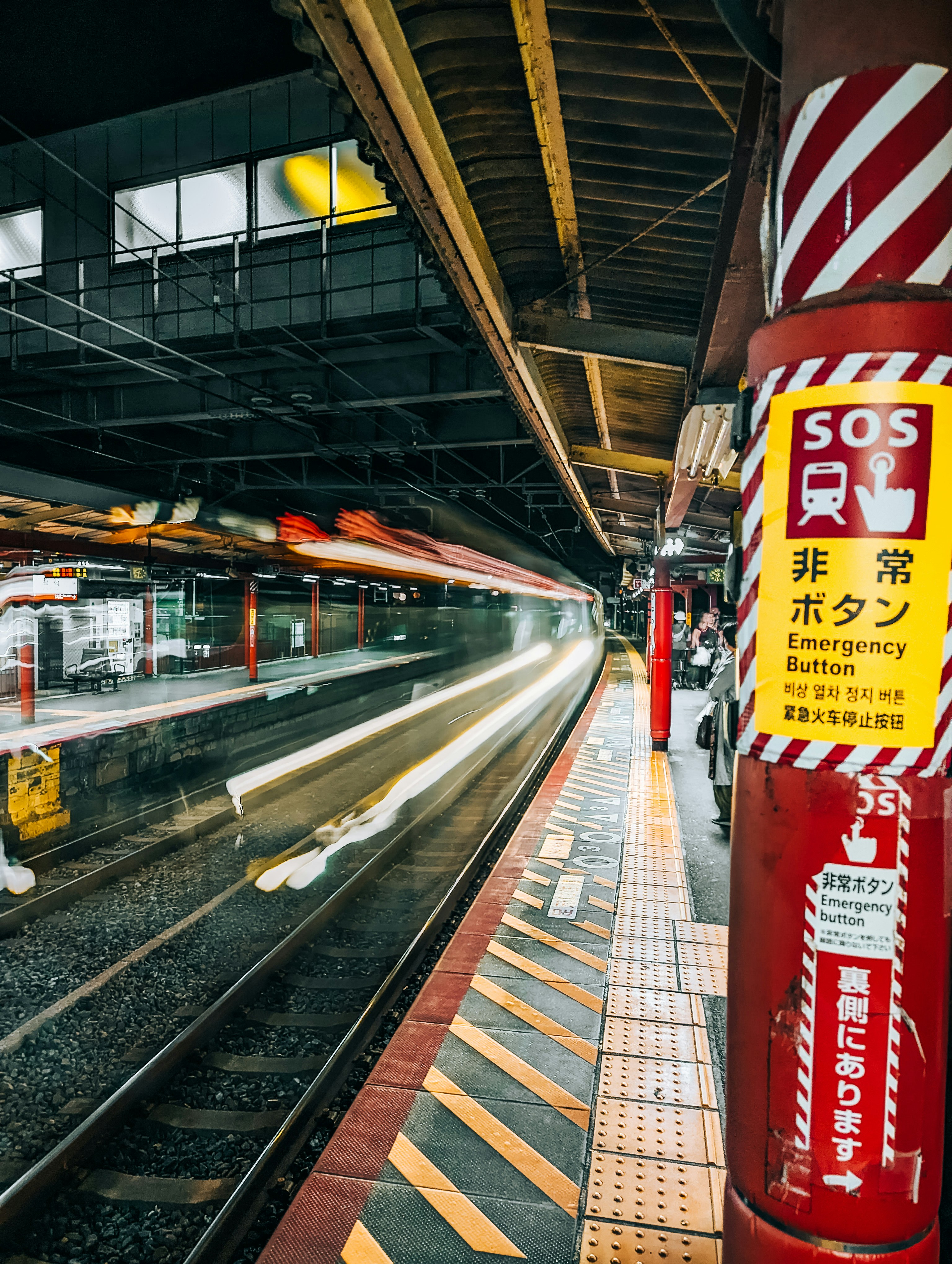 a train traveling down train tracks next to a train station