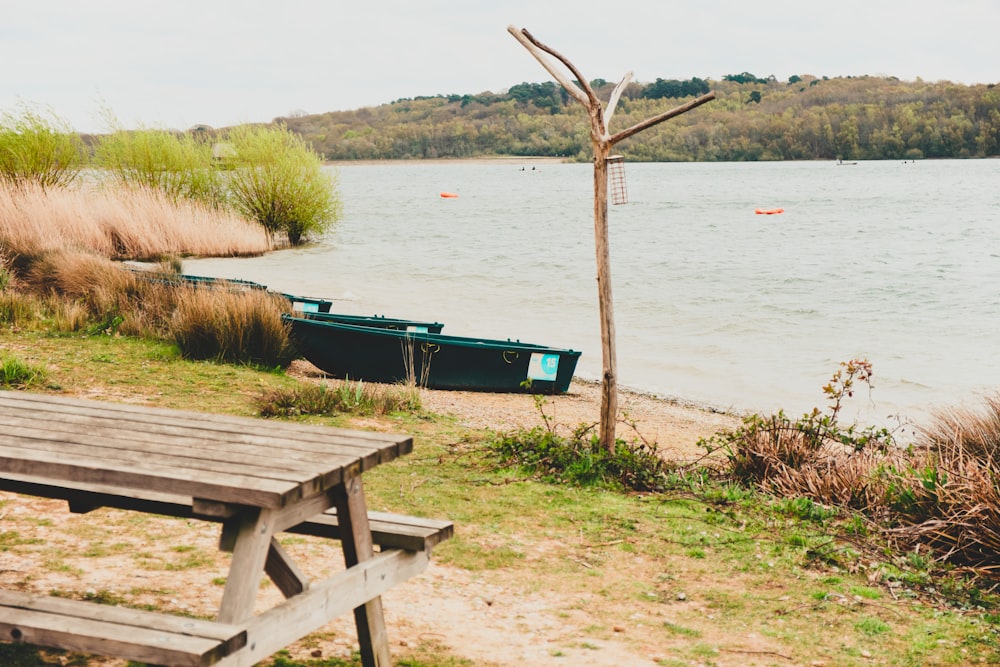 a wooden bench sitting next to a body of water
