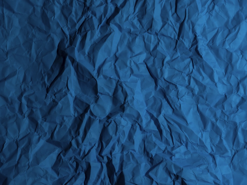 a piece of blue paper that is crumpled in half