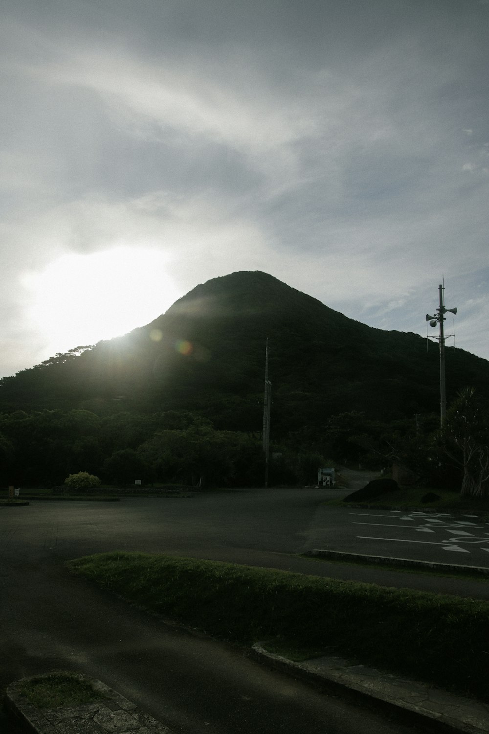 the sun is setting behind a mountain