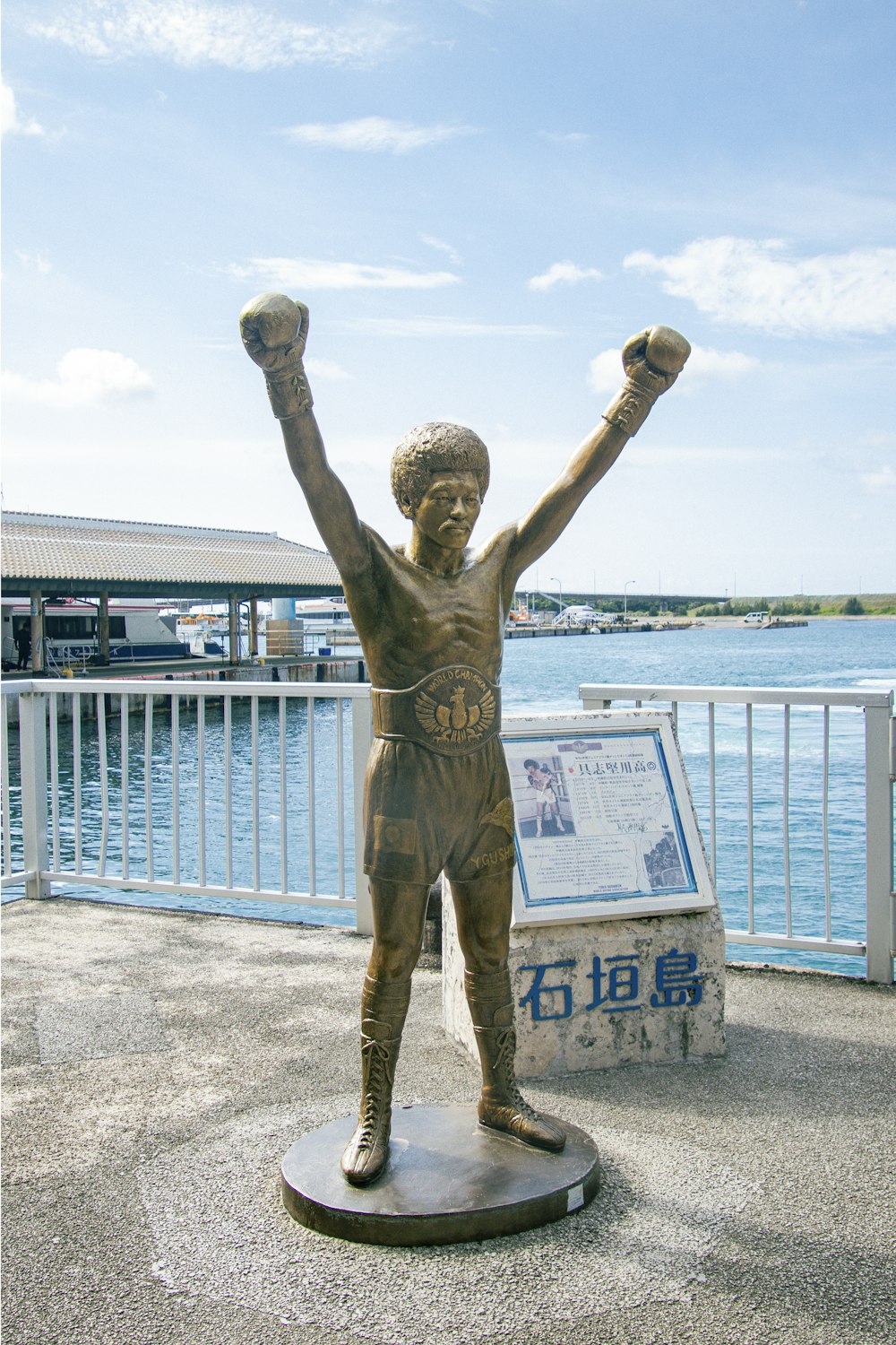 a statue of a man with his arms in the air