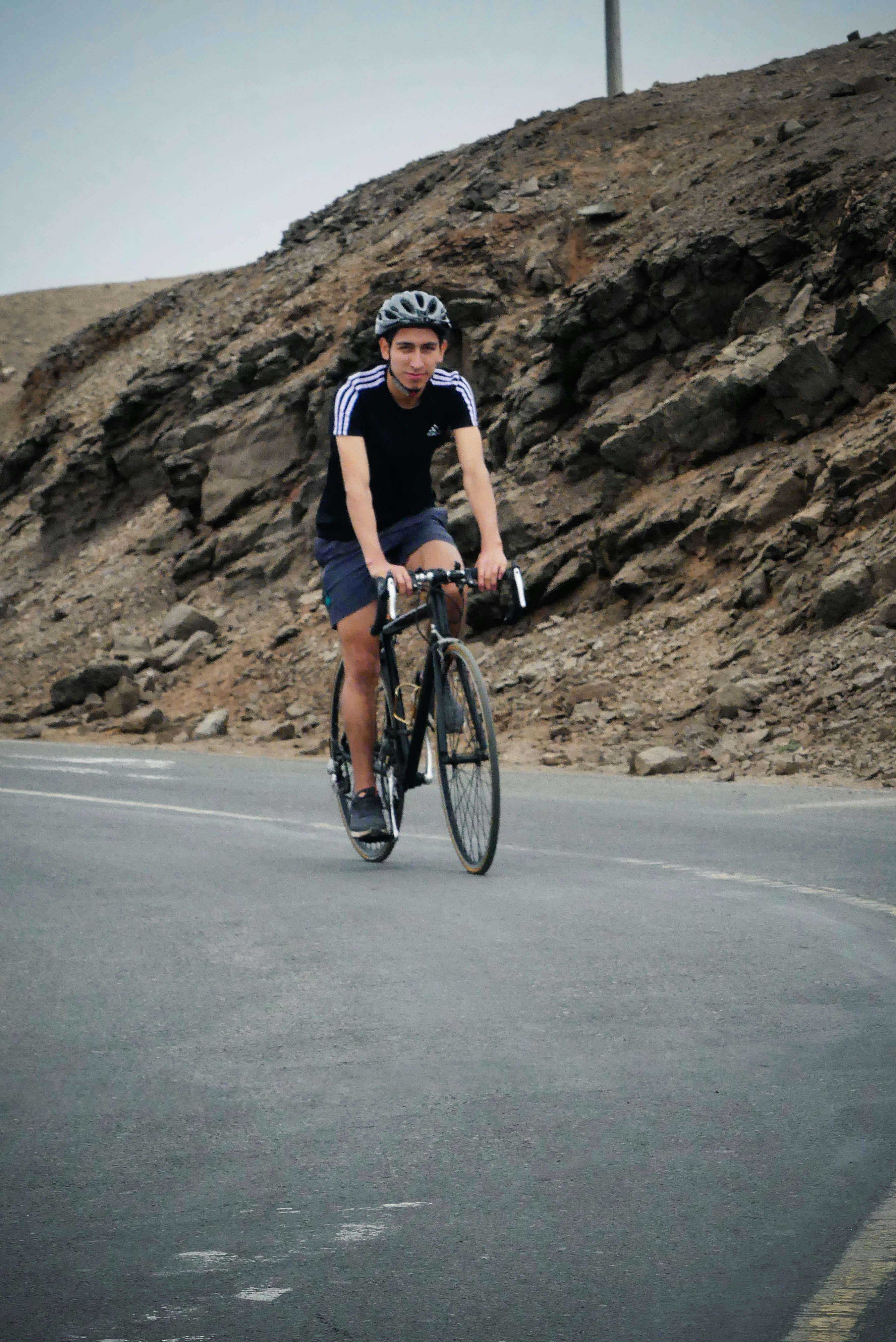 a man riding a bike down a curvy road