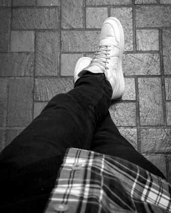 a person sitting on the ground with their legs crossed