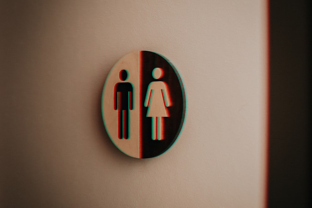 a bathroom sign with a male and female symbol on it