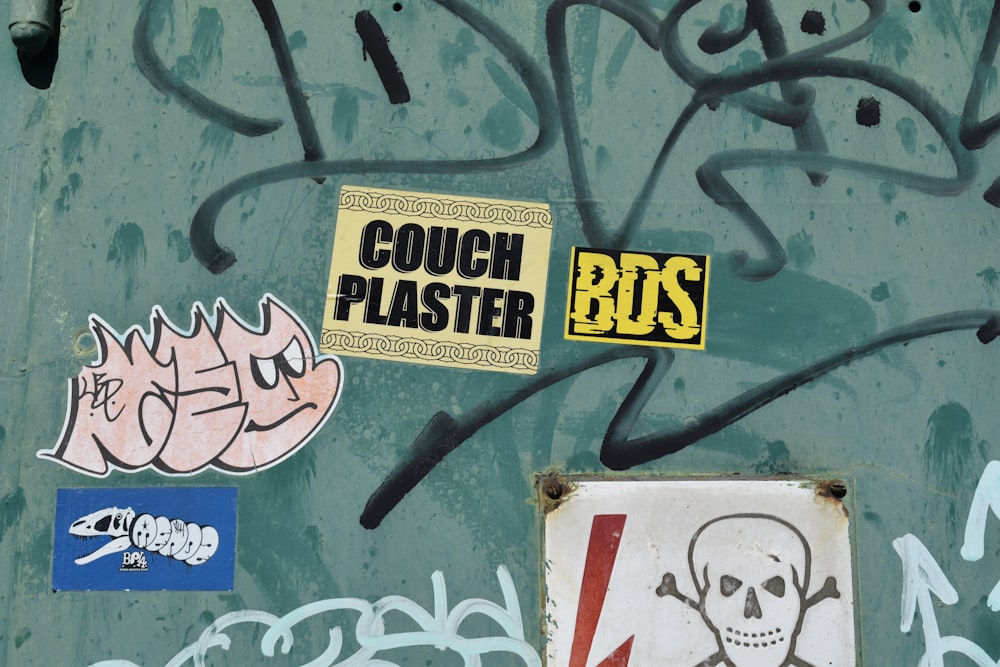 a bunch of stickers on the side of a wall