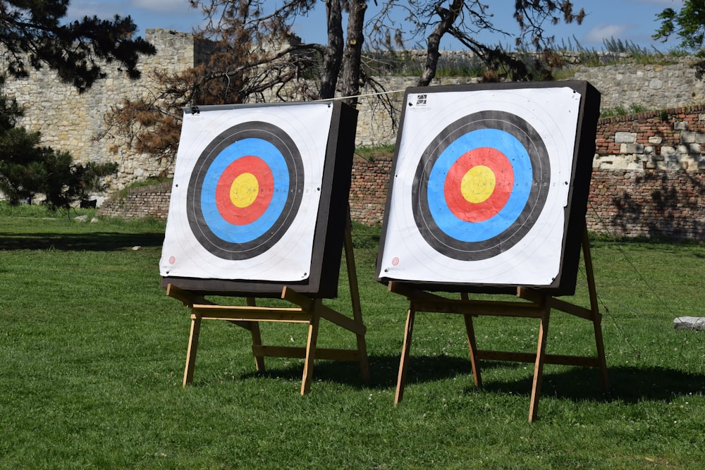 a couple of wooden easels with a target in the middle of them