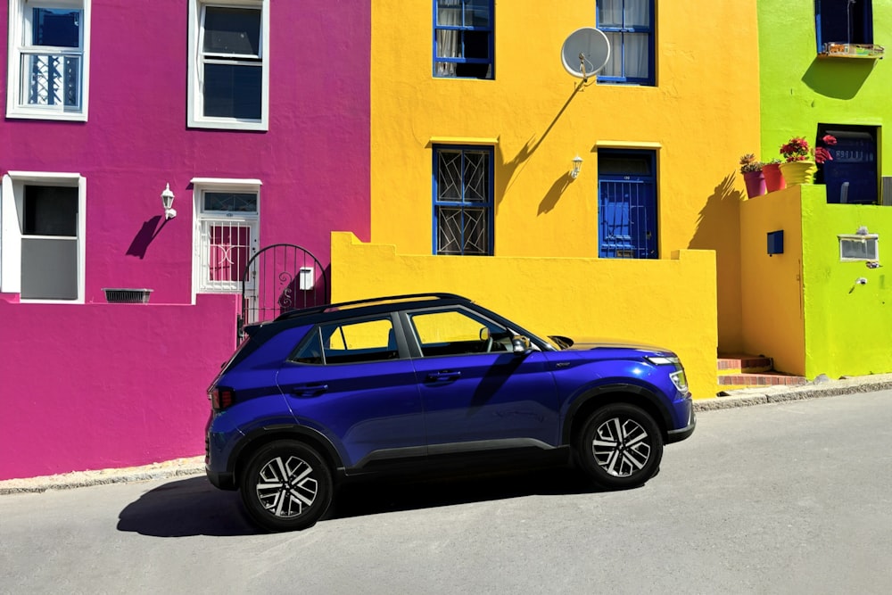 a car parked in front of a multi - colored building