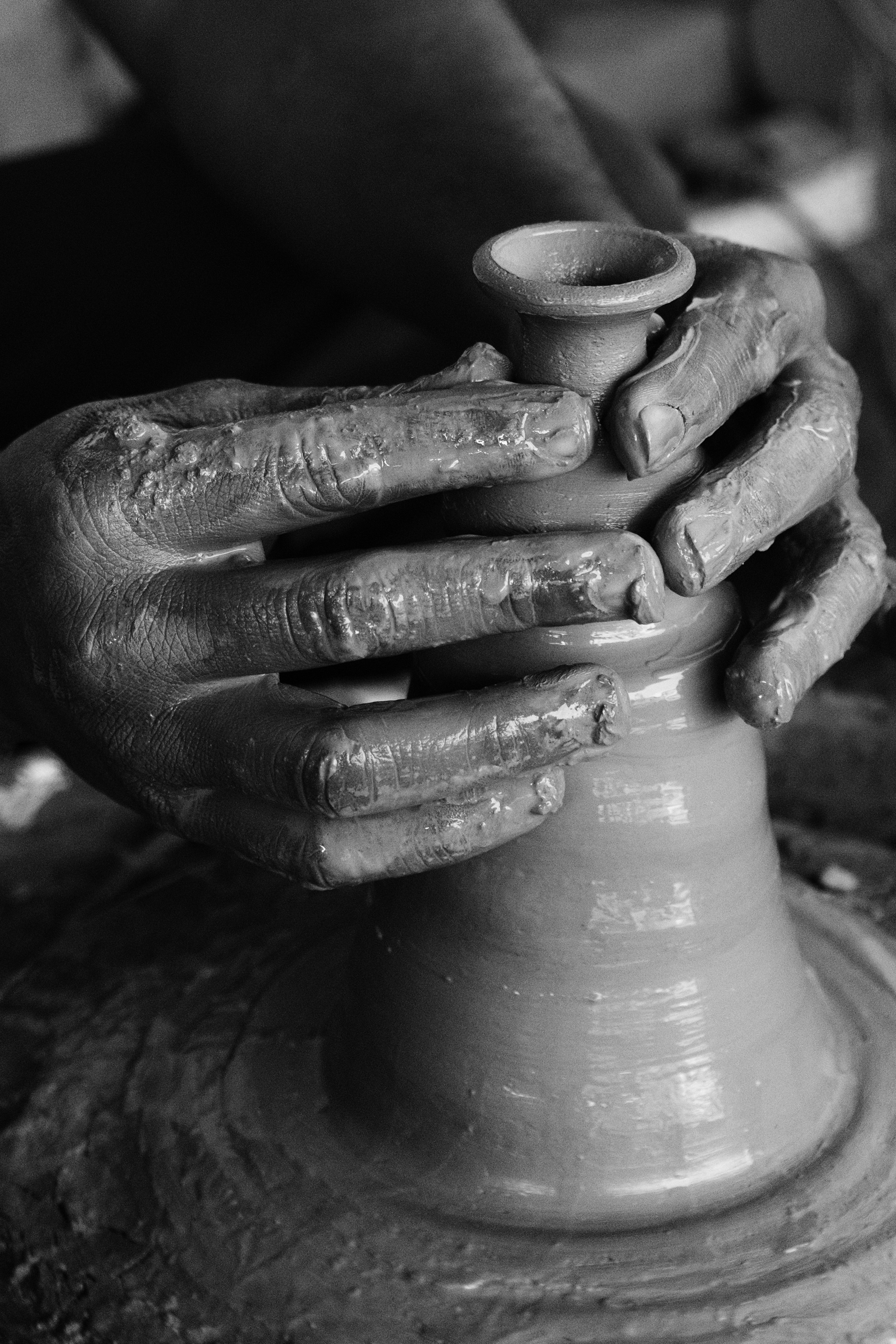 a person's hands on a pottery wheel