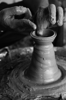 a person is making a pot on a potter's wheel