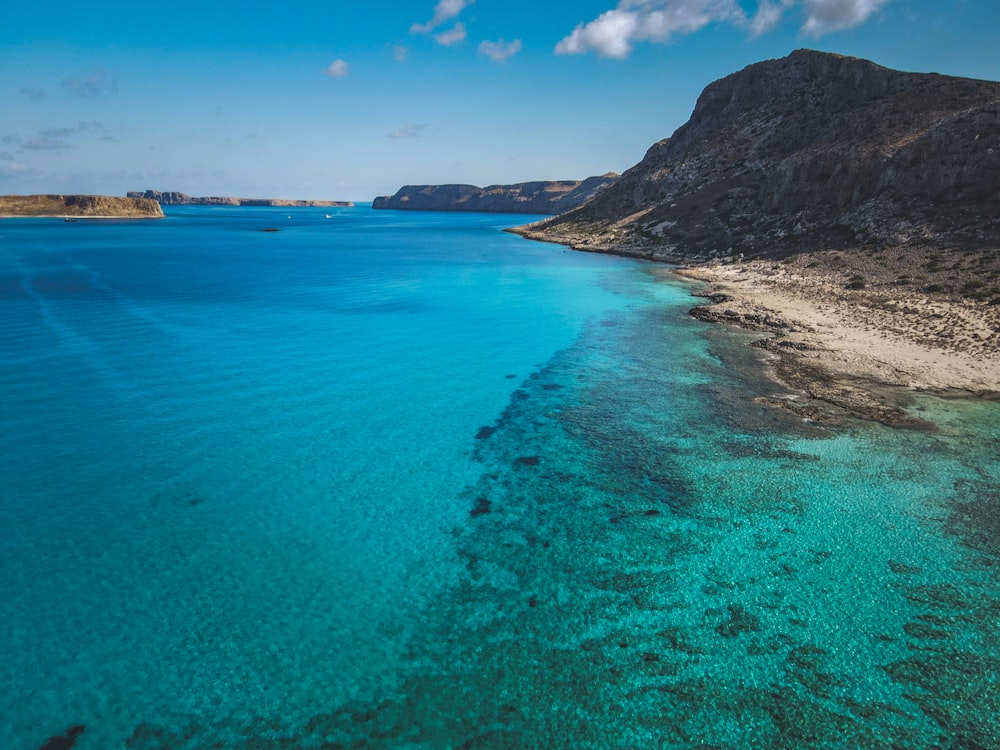 a body of water with a mountain in the background