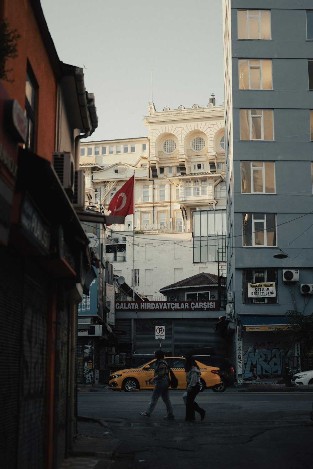 a couple of people walking across a street