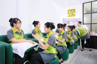 a group of women sitting on top of a green couch