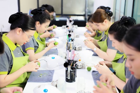 a group of women sitting at a long table