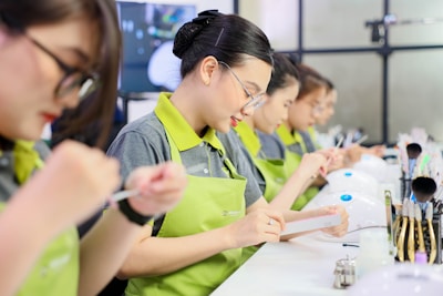 a group of women in green aprons working on a project
