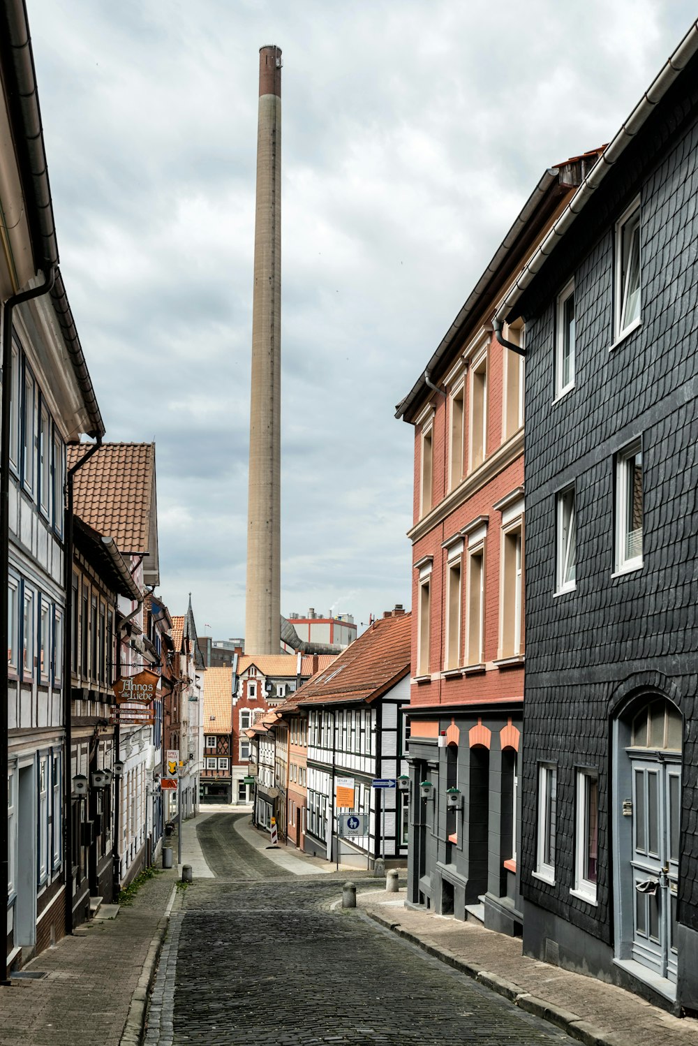 a street lined with buildings and a tall tower in the distance