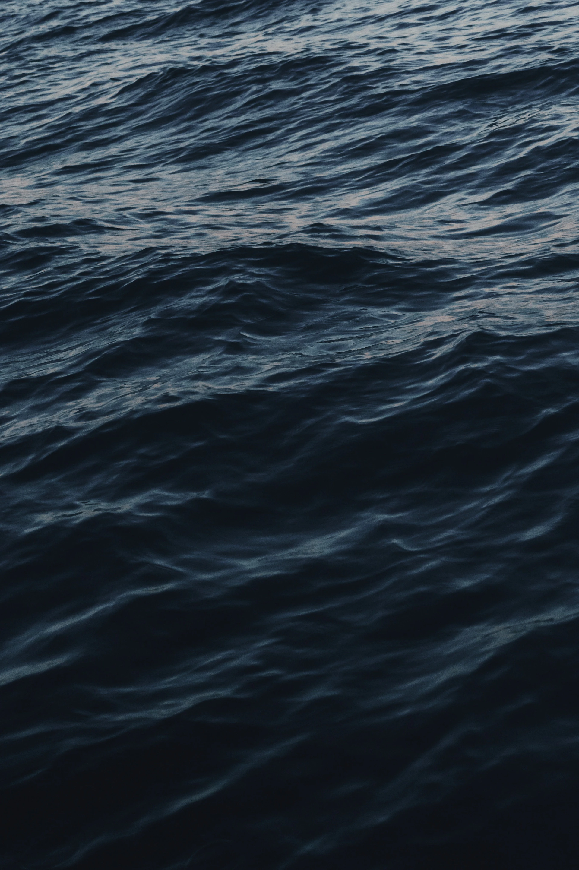 a large body of water with a boat in the distance