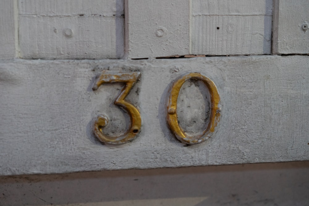 a close up of a number on a wall
