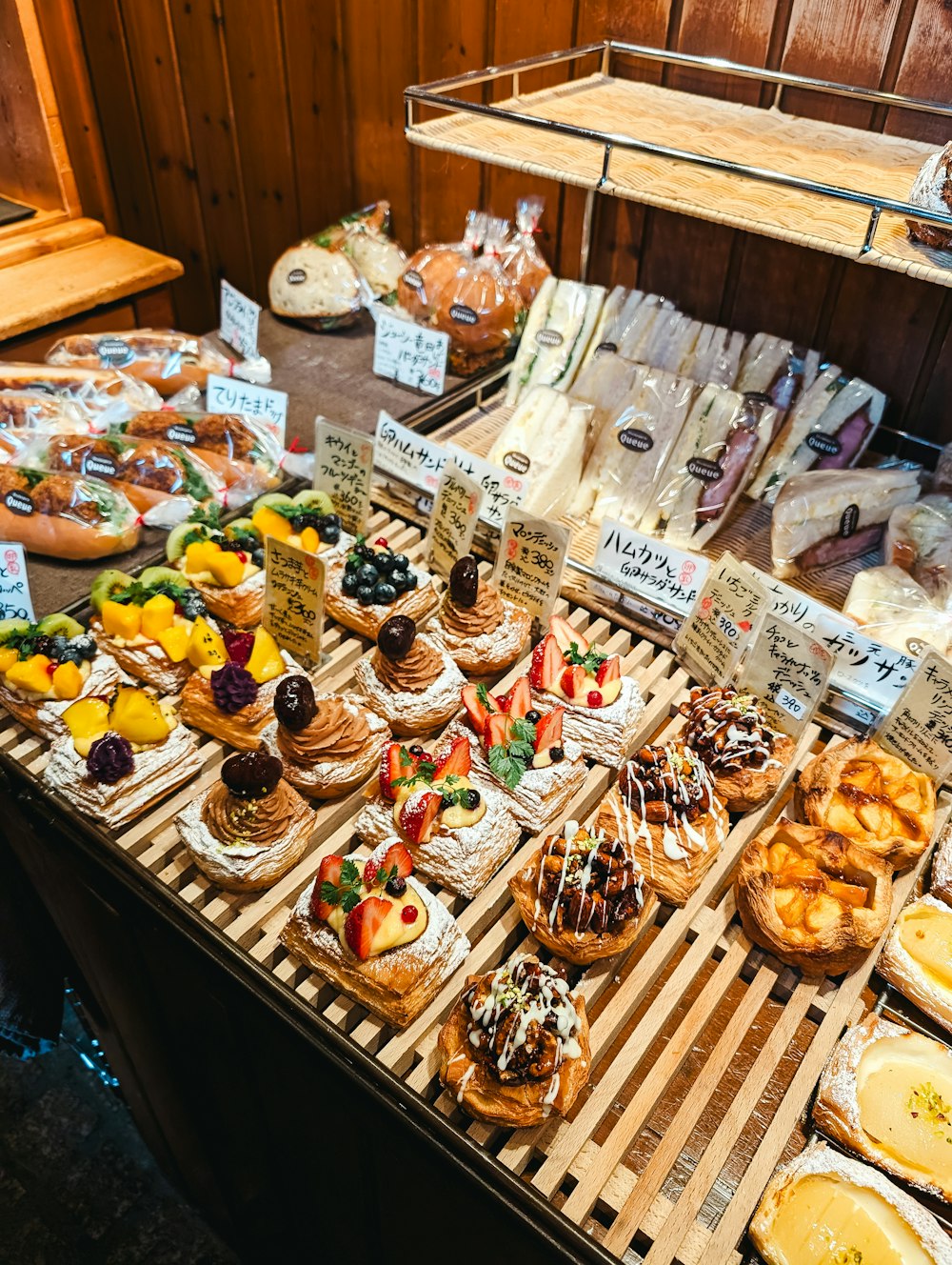 a wooden table topped with lots of pastries
