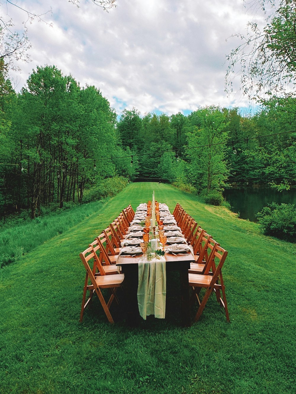 a long table set up in the middle of a field