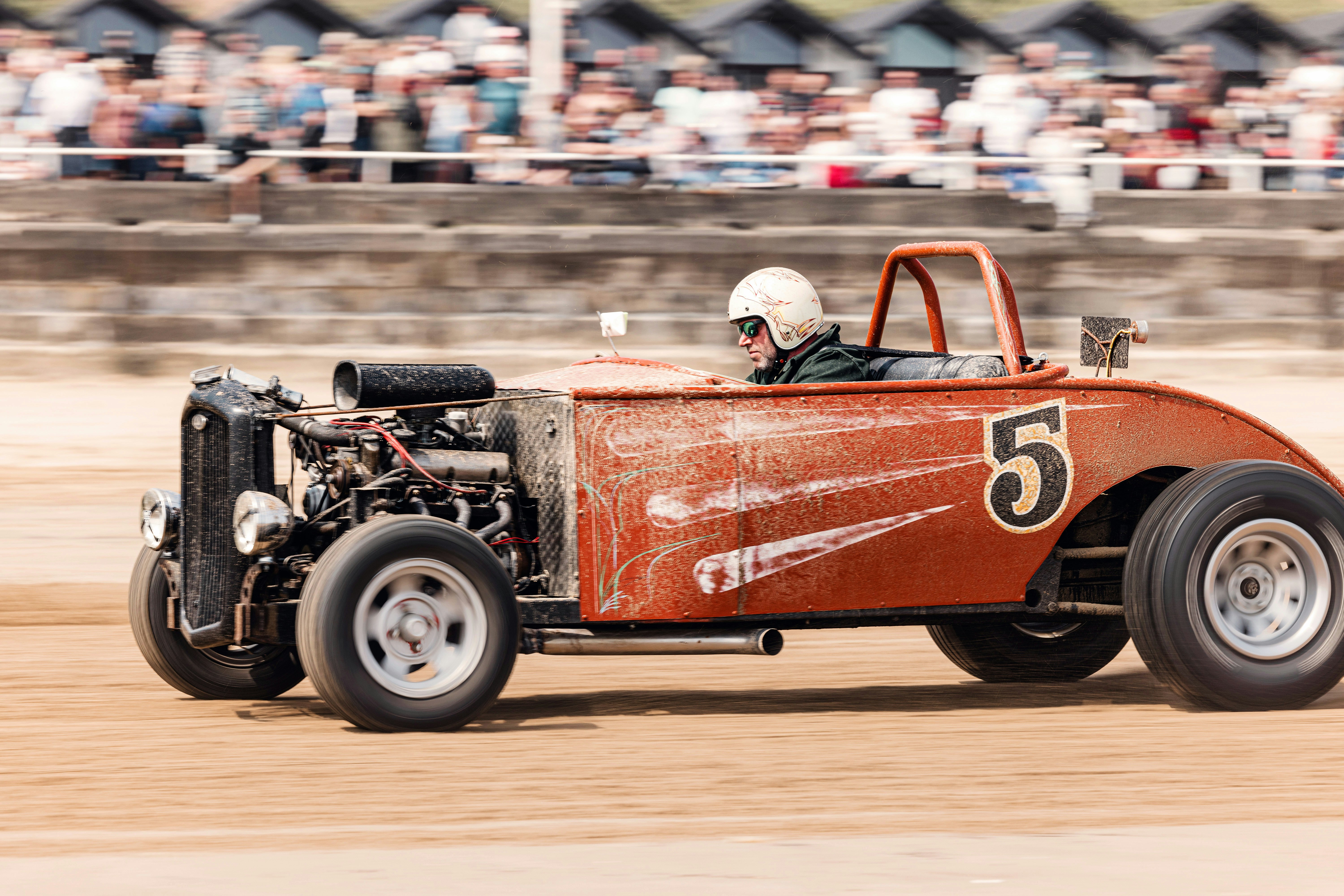 A man driving a red race car on a dirt track photo – Free Hot rod Image ...