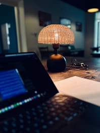 a laptop computer sitting on top of a wooden table