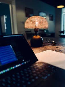 a laptop computer sitting on top of a wooden table