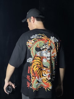 a man wearing a black shirt with a tiger on it