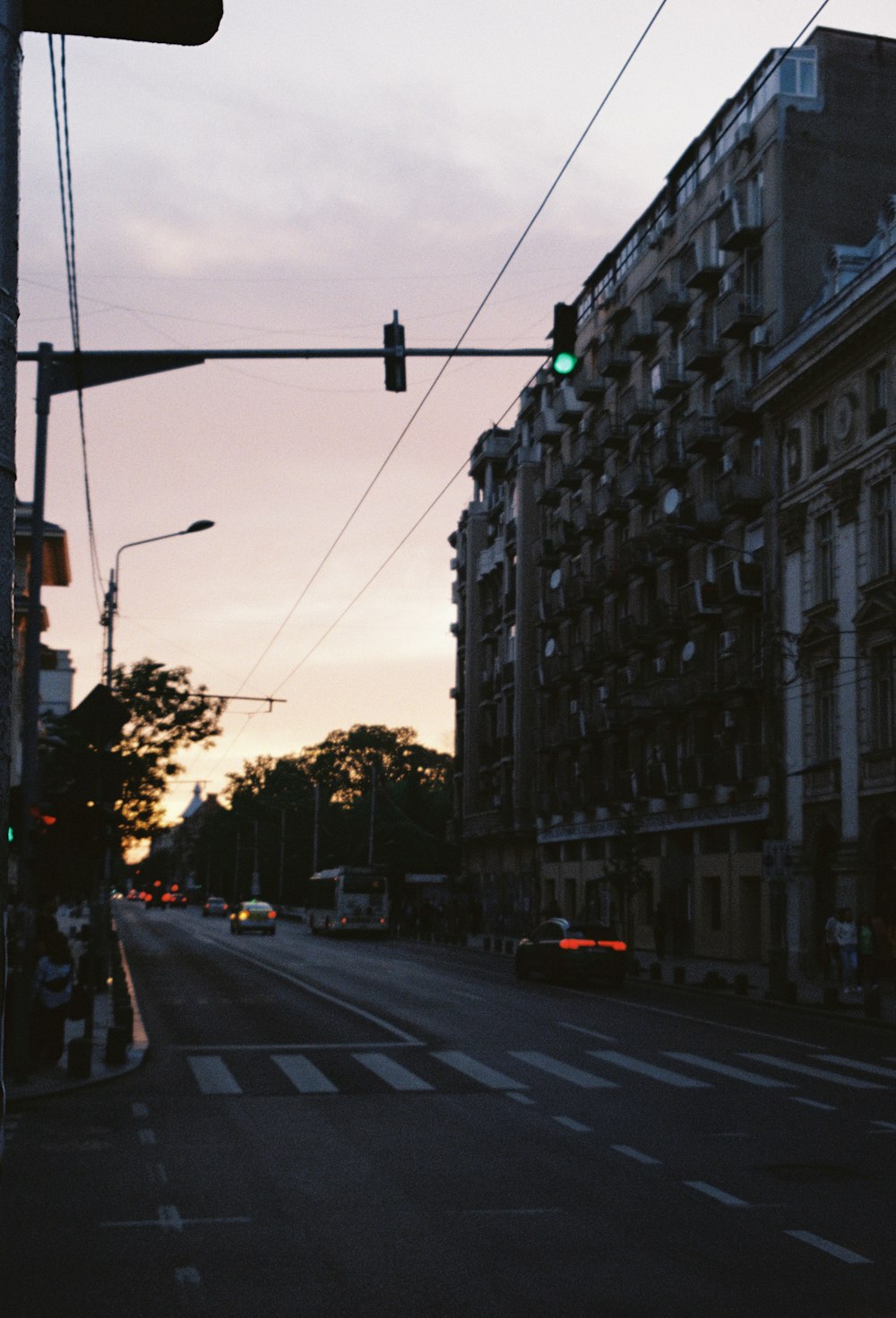 a traffic light hanging over a street next to tall buildings